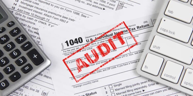 Online tax filing - federal 1040 form with computer keyboard and calculator