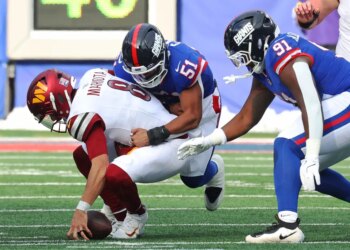 New York Giants player #51 tackles Washington Commanders player #8 Marcus Mariota.