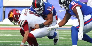 New York Giants player #51 tackles Washington Commanders player #8 Marcus Mariota.