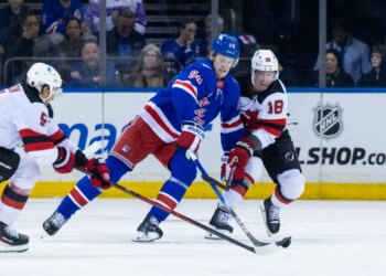New York Rangers center Adam Edstrom (84) and New Jersey Devils left wing Ondrej Palat (18) fight for possession of the puck.