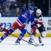 New York Rangers center Adam Edstrom (84) and New Jersey Devils left wing Ondrej Palat (18) fight for possession of the puck.