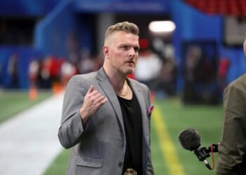 Pat McAfee speaking into a microphone during the Chick-fil-A Peach Bowl.