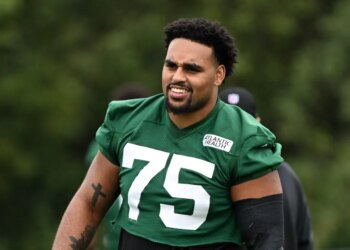 Jets guard Alijah Vera-Tucker smiling during practice.
