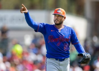 New York Mets pitcher Freddy Peralta points during a Spring Training game.
