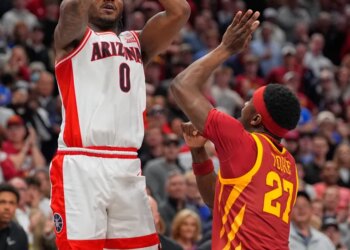 Jaden Bradley of Arizona shoots a game-winning basket over Killyan Toure of Iowa State.