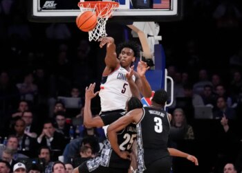 UConn forward Tarris Reed Jr. (5) blocks Georgetown guard Jeremiah Williams (25) during an NCAA college basketball game.