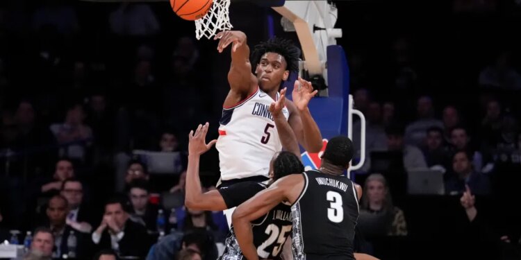 UConn forward Tarris Reed Jr. (5) blocks Georgetown guard Jeremiah Williams (25) during an NCAA college basketball game.