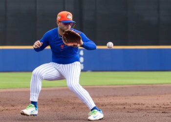 New York Mets' Bo Bichette fields balls at third base.