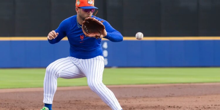 New York Mets' Bo Bichette fields balls at third base.