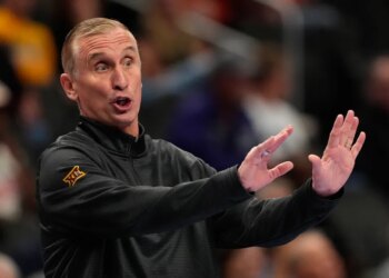 Arizona State head coach Bobby Hurley motioning to his players.