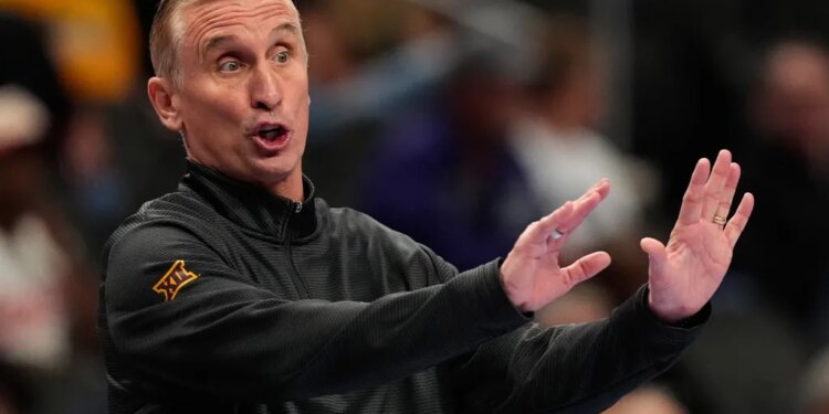 Arizona State head coach Bobby Hurley motioning to his players.