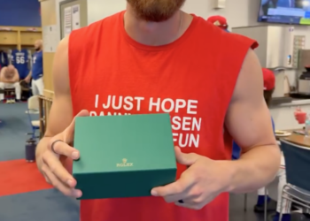 Texas Rangers star Brandon Nimmo holding a Rolex gift box.