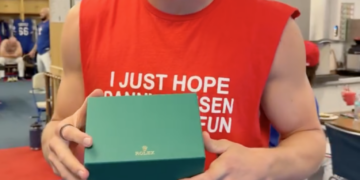 Texas Rangers star Brandon Nimmo holding a Rolex gift box.