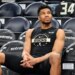 Giannis Antetokounmpo watching the warmup session from the bench.