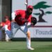 Jo Adell, wearing an Angels uniform, lunges to catch a baseball.