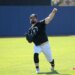 New York Yankees pitcher Carlos Rodón #55, throwing a multi-colored ball in the outfield during practice at Steinbrenner Field, the Yankees Spring Training home in Tampa, Florida.
