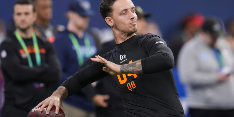Miami quarterback Carson Beck (04) runs a drill at the NFL football scouting combine in Indianapolis.