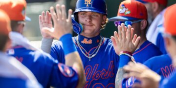 New York Mets’ Carson Benge (93) celebrates in the dugout after scoring on a wild pitch against the St. Louis Cardinals.