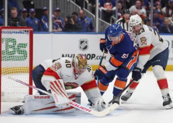 New York Islanders center Casey Cizikas (53) attempts a shot past Florida Panthers goaltender Daniil Tarasov (40) and center Carter Verhaeghe (23) during the first period of a game at UBS Arena in Elmont, N.Y. on Saturday, March 28, 2026.