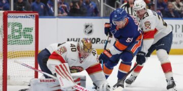 New York Islanders center Casey Cizikas (53) attempts a shot past Florida Panthers goaltender Daniil Tarasov (40) and center Carter Verhaeghe (23) during the first period of a game at UBS Arena in Elmont, N.Y. on Saturday, March 28, 2026.