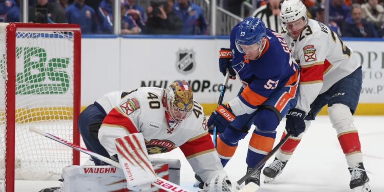 New York Islanders center Casey Cizikas (53) attempts a shot past Florida Panthers goaltender Daniil Tarasov (40) and center Carter Verhaeghe (23) during the first period of a game at UBS Arena in Elmont, N.Y. on Saturday, March 28, 2026.