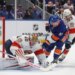New York Islanders center Casey Cizikas (53) attempts a shot past Florida Panthers goaltender Daniil Tarasov (40) and center Carter Verhaeghe (23) during the first period of a game at UBS Arena in Elmont, N.Y. on Saturday, March 28, 2026.