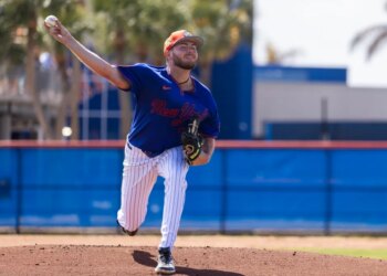 New York Mets pitcher Christian Scott throwing a baseball during spring training.