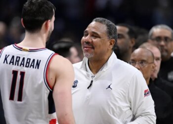 Georgetown head coach Ed Cooley speaking to UConn forward Alex Karaban.