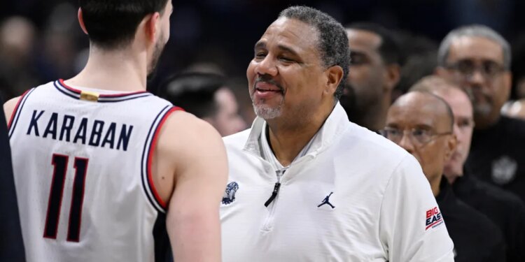 Georgetown head coach Ed Cooley speaking to UConn forward Alex Karaban.