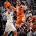Texas forward Nic Codie (10) leaps to block a pass from Texas A&M Aggies guard Rylan Griffen (3) during a basketball game.