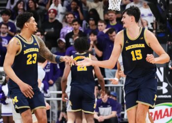 Michigan basketball players Aday Mara and Yaxel Lendeborg celebrate during a game against Northwestern.