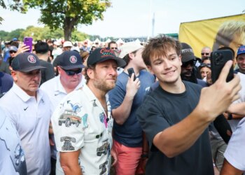 A young man taking a selfie with David Portnoy at the One Bite Pizza Festival.