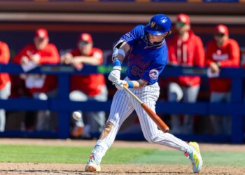New York Mets outfielder Carson Benge hits a single in the fifth inning against the St. Louis Cardinals during Spring Training.