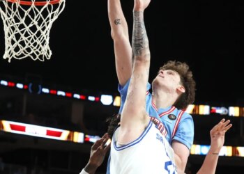 Dayton Flyers forward Amael L'etang (rear) puts back a shot for the game winning basket against the Saint Louis Billikens.