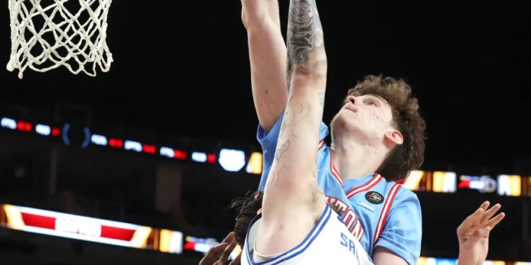 Dayton Flyers forward Amael L'etang (rear) puts back a shot for the game winning basket against the Saint Louis Billikens.