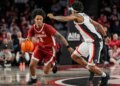 Tide guard Aden Holloway (2) dribbles against Georgia Bulldogs guard Marcus Millender (4) at Stegeman Coliseum.