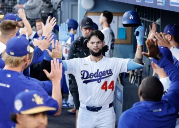 Los Angeles Dodgers center fielder Andy Pages (44) celebrates a home run in the dugout with his teammates.