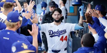 Los Angeles Dodgers center fielder Andy Pages (44) celebrates a home run in the dugout with his teammates.