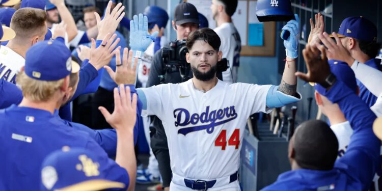 Los Angeles Dodgers center fielder Andy Pages (44) celebrates a home run in the dugout with his teammates.