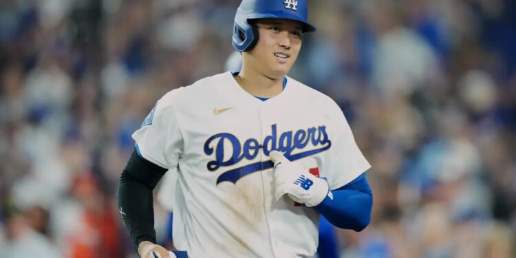Shohei Ohtani in a Los Angeles Dodgers uniform and helmet on the field.