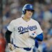 Shohei Ohtani in a Los Angeles Dodgers uniform and helmet on the field.