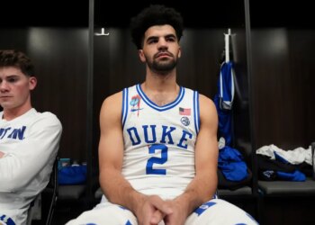 Duke guard Cayden Boozer sits in the locker room after their Elite Eight game.