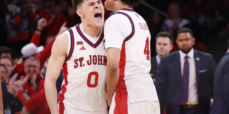 Dylan Darling (left) celebrates with Oziyah Sellers during the second half of St. John's 72-52 Big East title-clinching win over  UConn on March 14, 2026 at the Garden.