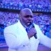 Gospel singer Keith Williams Jr. singing the national anthem with a microphone that has "Dodgers" written on it.