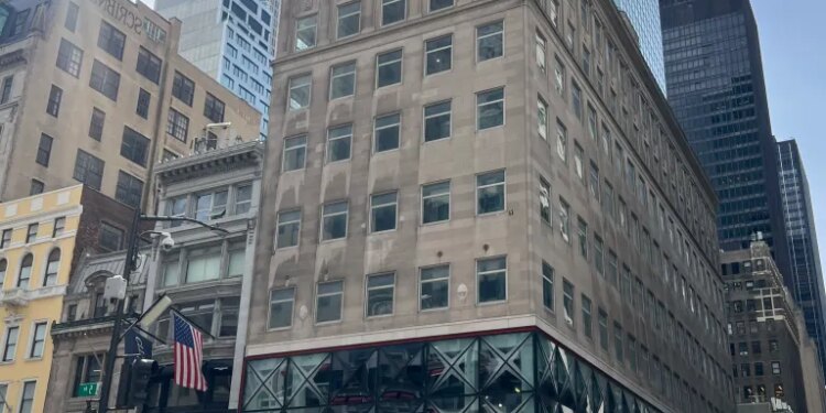The 609 Fifth Ave building, with a Puma store on the ground floor, on a busy New York City street.