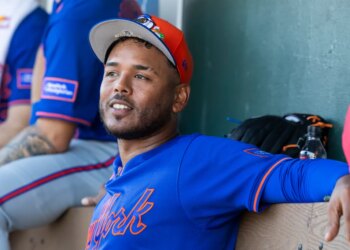 New York Mets Pitcher Freddy Peralta (51) sits in the dugout during Spring Training.