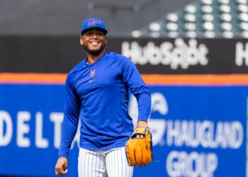 New York Mets Pitcher Freddy Peralta smiles during a workout.