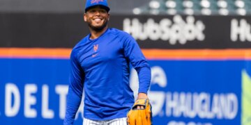 New York Mets Pitcher Freddy Peralta smiles during a workout.