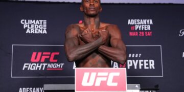 Israel Adesanya on the scale during the UFC Fight Night official weigh-ins for Adesanya vs Pyfer.