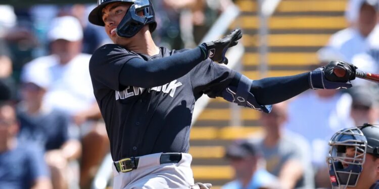 New York Yankees shortstop George Lombard Jr. (96) hits a two-rbi single against the Minnesota Twins.